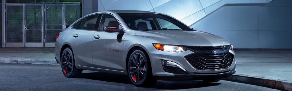 2025 Chevy Malibu parked in front of a building