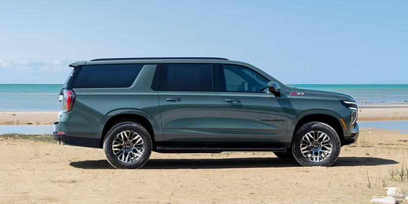 2026 Chevrolet Suburban parked on the beach, showcasing its design, available in Amarillo, TX.