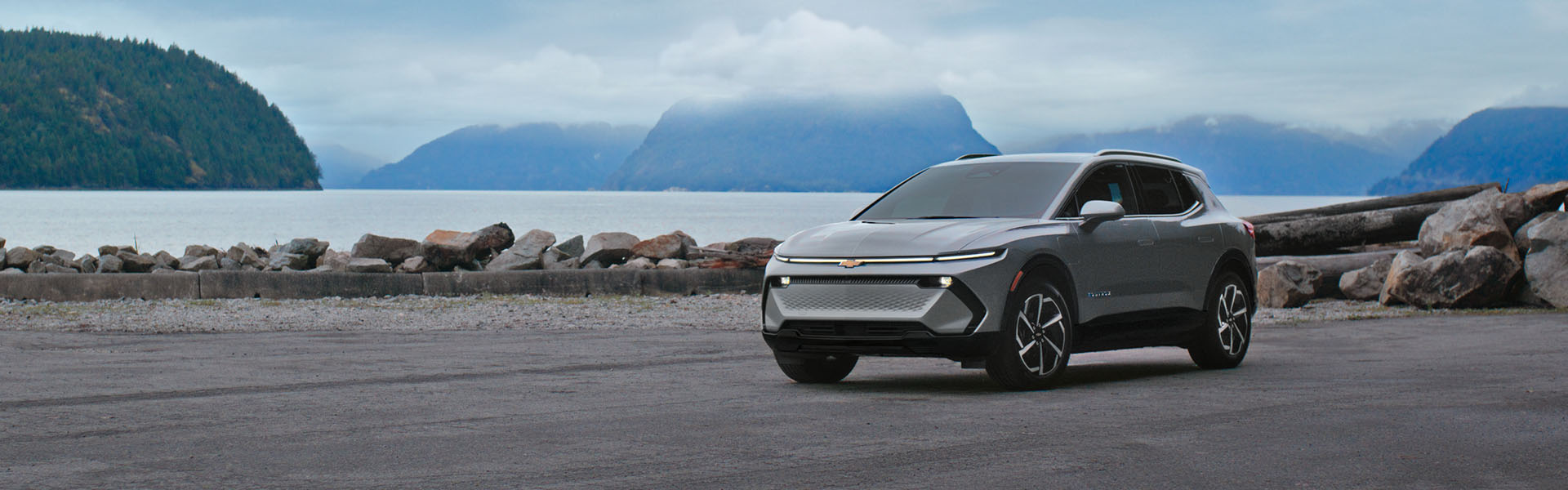 Front three-quarter view of the 2026 Chevrolet Equinox EV parked near a coastal shoreline